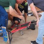 Fixing the bicycle of a homeless man.